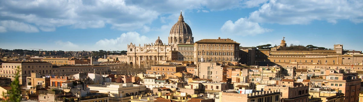 Panoramic view of Rome featuring St. Peter's Basilica and the Vatican City skyline under a bright blue sky with scattered clouds - Hotel Santa Maria Maggiore, BZAR hotels in Rome